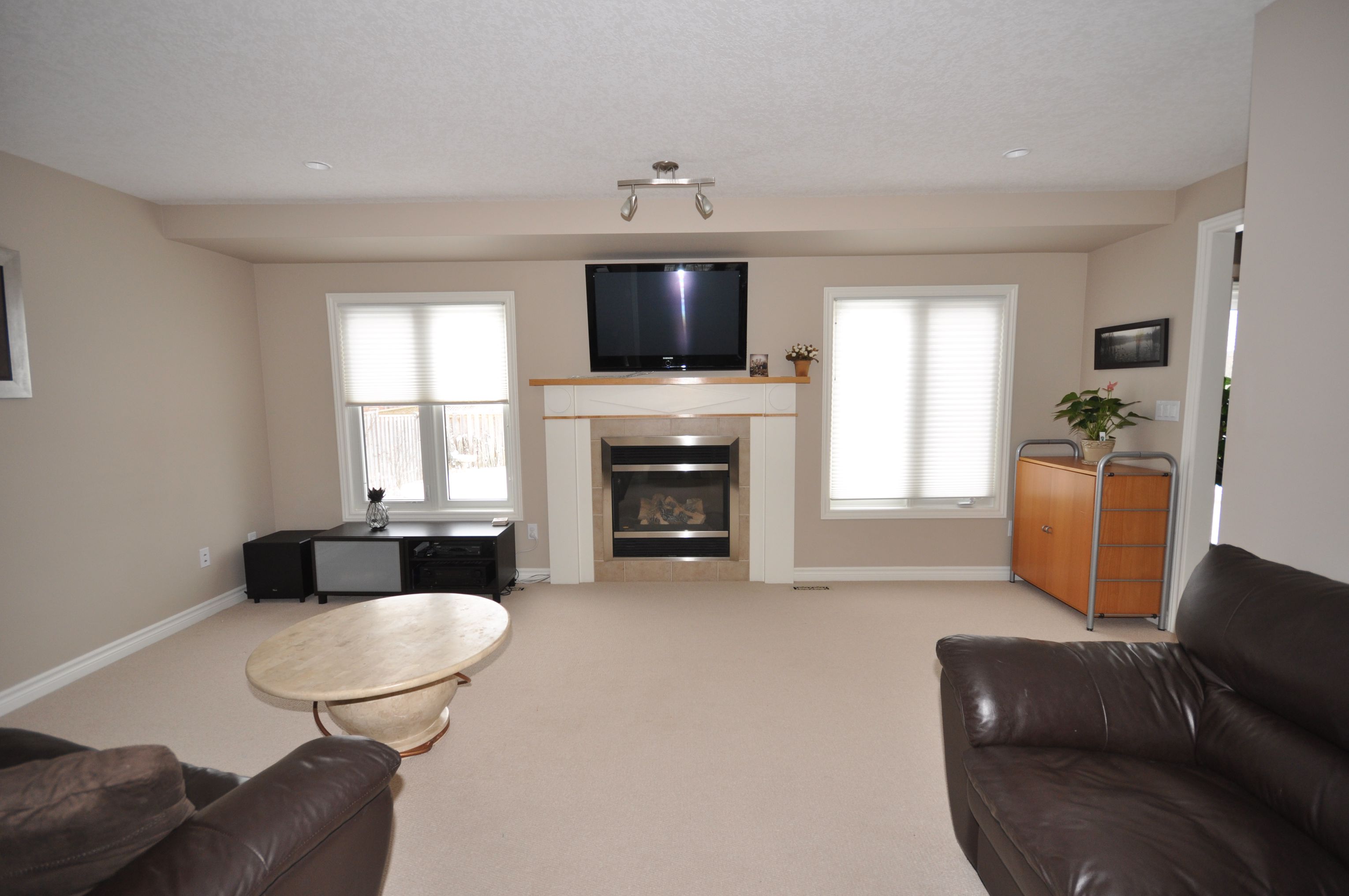 Spacious great room with gas fireplace & bright sunny windows