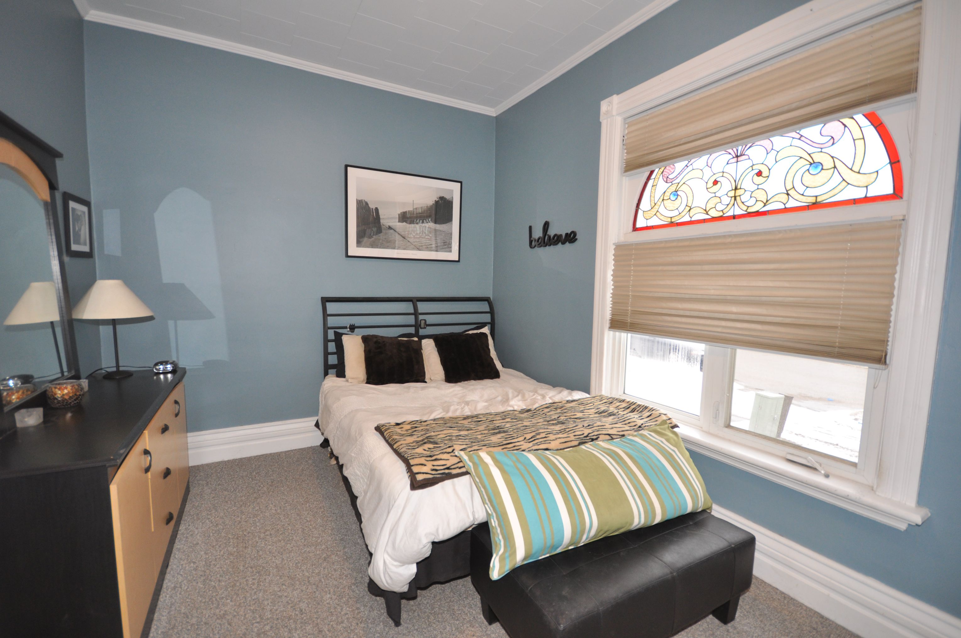 Master bedroom with stained glass window