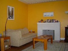 Large living room with a wood burning fireplace. 