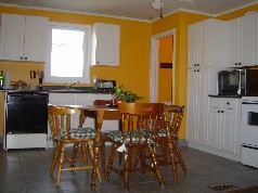 Newer eat in white kitchen open to living room 