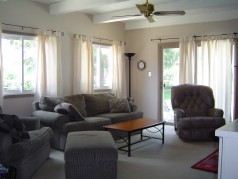 Sunken main floor family room with built in bookshelves, large windows & patio doors to the pool 