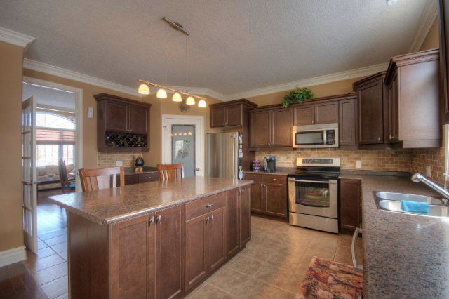 Staggered Cabinets, Floating Island & Walk-in Pantry