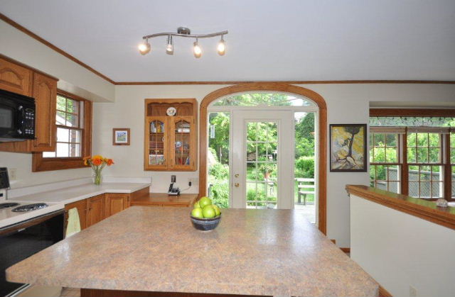 Kitchen with terrace door to the private rear yard and deck for family bbq