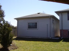 Back view of the newer oversized insulated garage with hydro. 