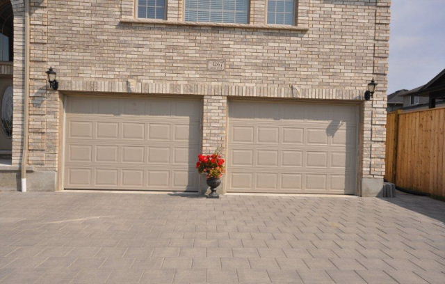 Triple staggered stone drive leading to Oversized 2 car garage