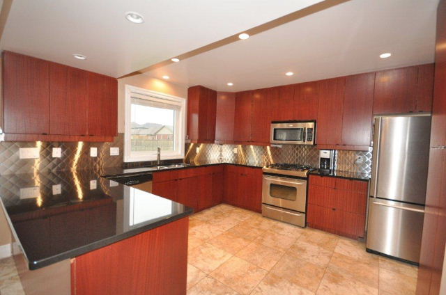 Black granite counter and stainless backsplash