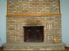 Family room with a wonderful corner floor to ceiling brick wood burning fireplace with a heatilator. 