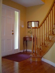 Spacious foyer has newer wide plank hardwood flooring & circular stairage to 2nd floor 