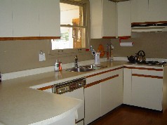 European kitchen has lots of cupboard and counter space plus hardwood flooring 