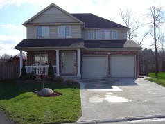2 storey home with attractive covered front porch, concrete drive & walkway! 