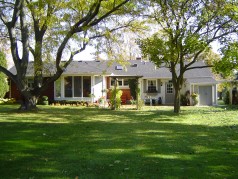 Back of house shows mature trees & landscaping 