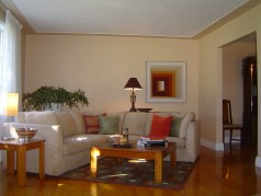 Large living room with newer trim and warm hardwood 