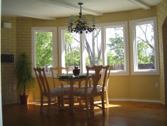 Eating area with lots of sunny windows overlooking the pool 