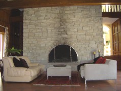 Floor to ceiling log burning fireplace is the focal point of this room 