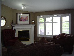 Corner gas fireplace, and sunny windows in main floor family room 