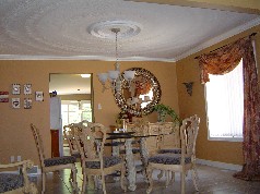 Pillared dining room with decorative ceiling 