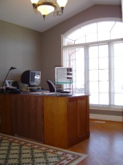 Front bedroom with french doors, vaulted ceiling and hardwood flooring 