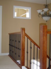 Upstairs foyer with transom window into main bathroom. 