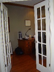 Double french doors leading to main floor den located near the front of the house 