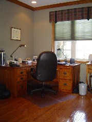 Main floor den has built in oak bookshelves, oak trim and crown molding. 