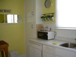 Sunny kitchen with lots of counter space and large cupboards plus pantry