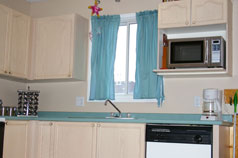 Lots of cupboards in sunny kitchen