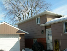 Side view of house and garage with entrance to the kitchen