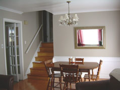 Bright and sunny formal dining room with hardwood floors