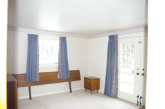 Master Bedroom with Terrace doors to the wrap around Sundeck at the front of the house