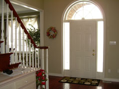 Large, bright foyer with hardwood flooring