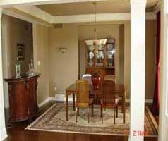 Gleaming hardwood in pillared dining room at the front of the house.